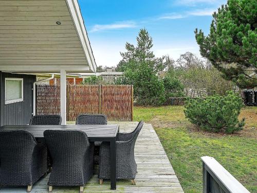 a patio with a table and chairs on a deck at 6 person holiday home in Slagelse in Slagelse