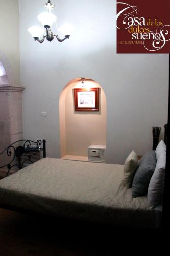 Una cama o camas en una habitación de Casa de los Dulces Sueños