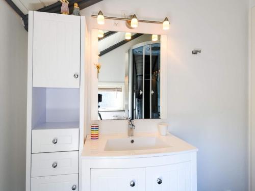 a bathroom with a sink and a mirror at Secluded Haven in Rindby in Fanø