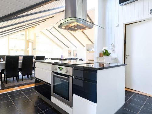 a kitchen with a black and white stove top oven at Secluded Haven in Rindby in Fanø