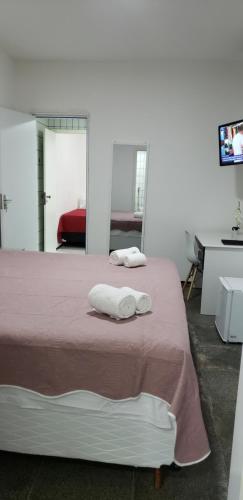 a bedroom with a bed with two towels on it at LIVE IN FORTALEZA HOTEL in Fortaleza