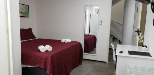 a bedroom with a bed with two towels on it at LIVE IN FORTALEZA HOTEL in Fortaleza