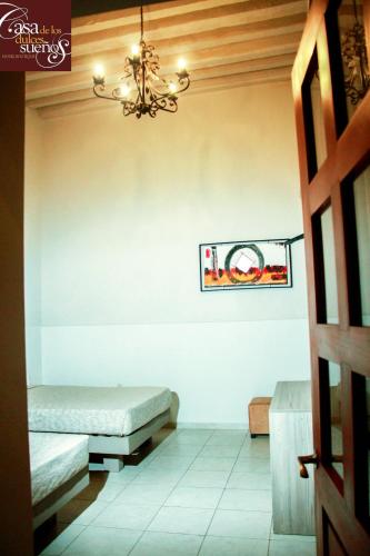 Una cama o camas en una habitación de Casa de los Dulces Sueños