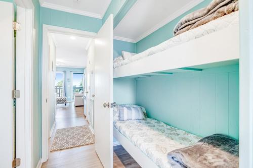 a bedroom with blue walls and bunk beds at Seacabin Villa 230-B in Isle of Palms