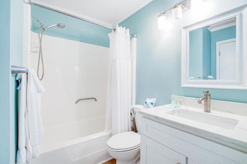 a bathroom with a white toilet and a sink at Seacabin Villa 230-B in Isle of Palms