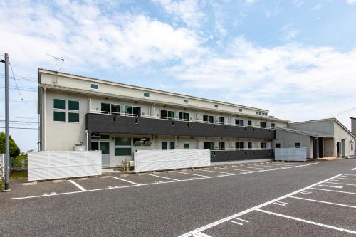 an empty parking lot in front of a building at Tabist Hotel Takagiya Iwaki in Hisanohama