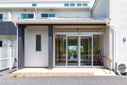 an entrance to a building with sliding glass doors at Tabist Hotel Takagiya Iwaki in Hisanohama