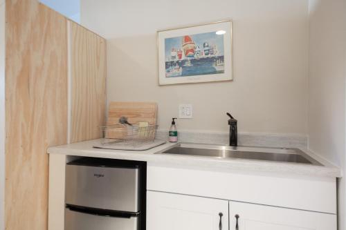 a kitchen with a sink and a refrigerator at Overlooking Marina del Rey sailboats, is Green Ginger Playa Del Rey on the bluff, in Los Angeles