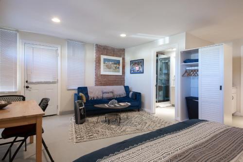 a bedroom with a blue bed and a table at Overlooking Marina del Rey sailboats, is Green Ginger Playa Del Rey on the bluff, in Los Angeles