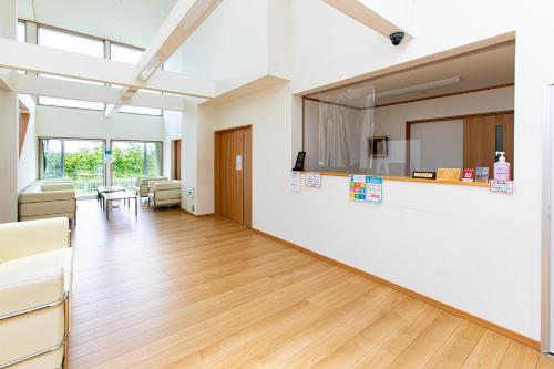 an office with a waiting room with a table and chairs at Tabist Hotel Takagiya Iwaki in Hisanohama