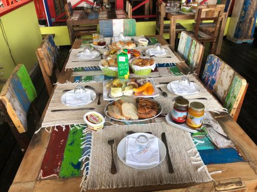 a long wooden table with food on it at La Perle Tahaa in Tapu' amu