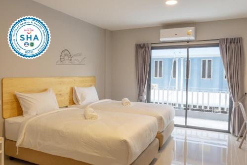 two beds in a bedroom with a sign that reads skip at Fine Bed Hotel in Nonthaburi