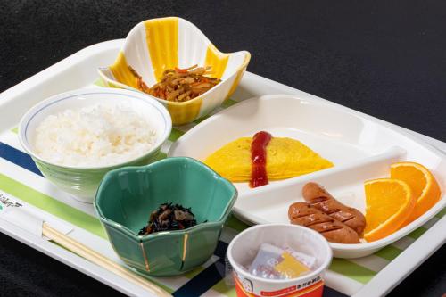 a tray with rice and other food items on it at Tabist Hotel Takagiya Iwaki in Hisanohama