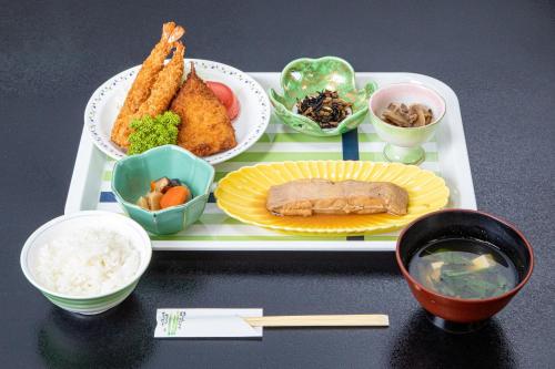 a tray of food with different types of food on it at Tabist Hotel Takagiya Iwaki in Hisanohama