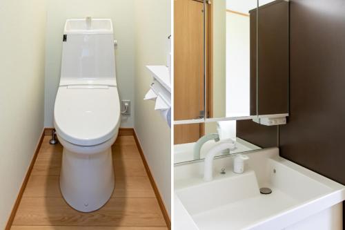 a bathroom with a toilet and a sink at Tabist Hotel Takagiya Iwaki in Hisanohama