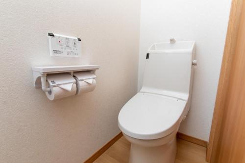 a bathroom with a white toilet in a room at Tabist Hotel Takagiya Iwaki in Hisanohama