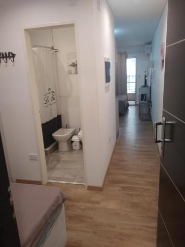 a hallway with a bathroom with a toilet and a sink at Aires Verdes Salta in Salta
