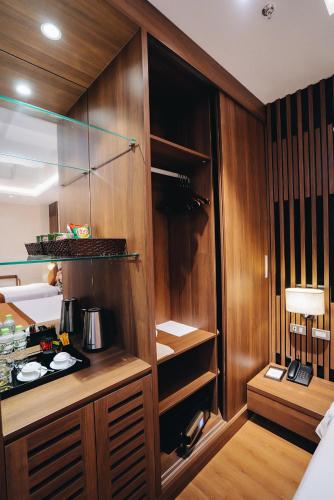 a kitchen with wooden cabinets and a counter top at Manh Quan Luxury Hotel in Yen
