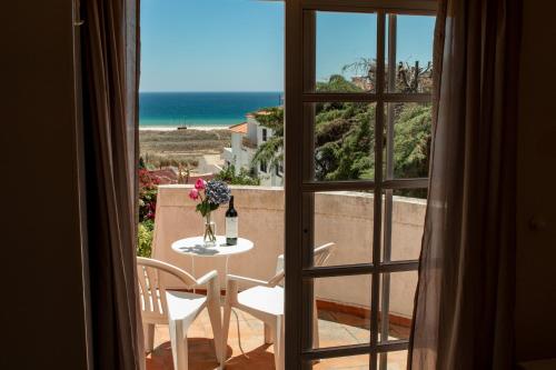 a room with a table and a view of the ocean at York House in Lagos