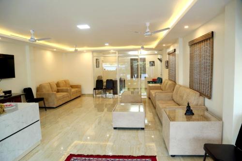 a large living room with couches and a table at THAAI RESIDENCY in Tiruvannāmalai