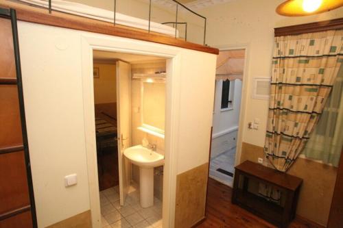 a bathroom with a sink and a mirror at En Ermoupoli in Ermoupoli