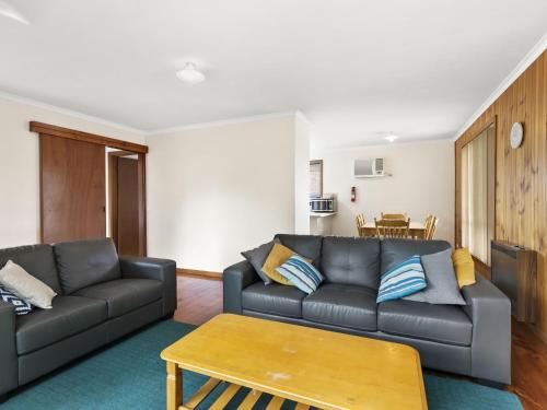 a living room with a couch and a table at Muirfield Beach Unit 1-23 in Torquay