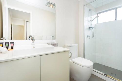 a bathroom with a toilet and a sink and a shower at Parkland View Sanctuary - EXECUTIVE ESCAPES in Perth