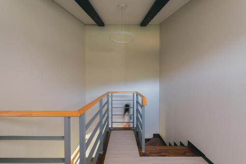 a staircase in a room with white walls and wooden floors at Kylin Villa resort Jeju in Seogwipo