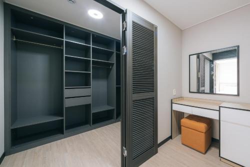 a walk in closet with a desk and a window at Kylin Villa resort Jeju in Seogwipo
