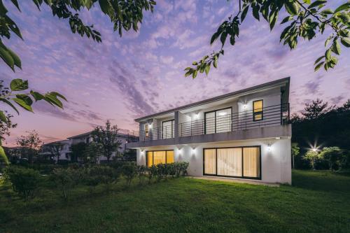 a rendering of a house at dusk at Kylin Villa resort Jeju in Seogwipo