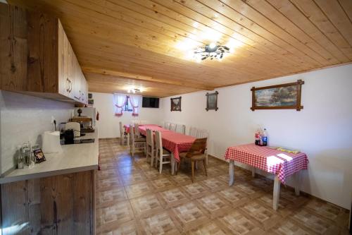 una cucina e una sala da pranzo con due tavoli e sedie di Къща за гости детелина - лина a Sapareva Banya