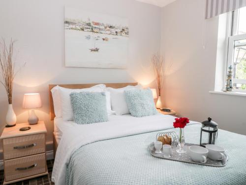 a bedroom with a bed with a tray of food on it at Nett's Coastal Escape in Filey