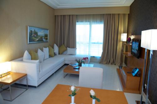 a living room with a white couch and a table at Belle Vue Building in Dubai