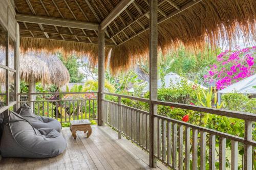 a living room with a couch on a porch at Le Yanandra Bali Resort in Jimbaran