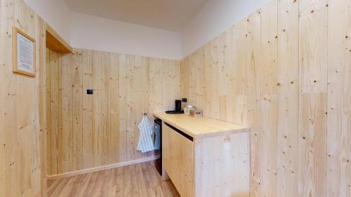 a room with wooden walls and a wooden counter at Penzion Sabina in Vernár
