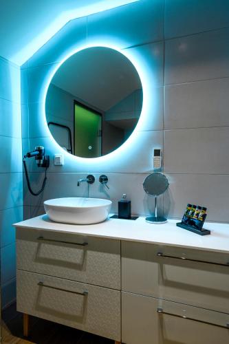 a bathroom with a sink and a mirror at BLACKHAUS Apartments in Thessaloniki