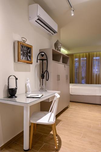 a white desk with a white chair in a room at BLACKHAUS Apartments in Thessaloniki