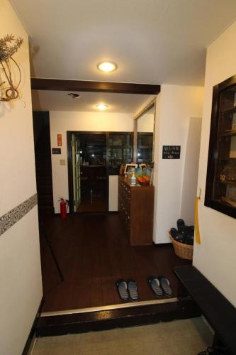 a hallway with two pairs of shoes on the floor at Stella八ヶ岳原村-星空,サウナ,BBQ,大型スクリーンを楽しめる八ヶ岳の貸切宿 in Hara
