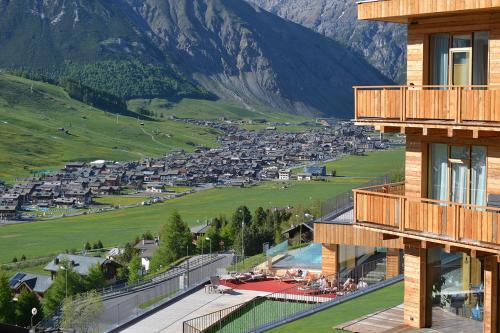 a view from the balcony of a resort in the mountains at Alpen Resort Bivio in Livigno
