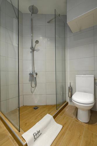 a bathroom with a shower and a toilet at BLACKHAUS Apartments in Thessaloniki
