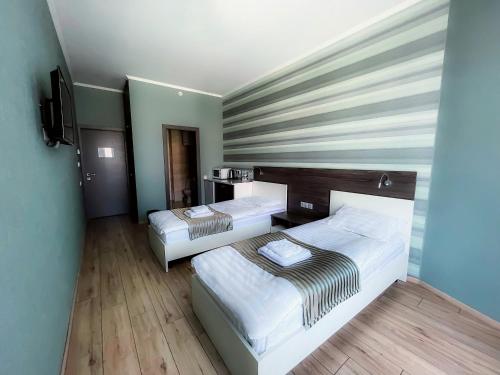 Łóżko lub łóżka w pokoju w obiekcie SeaLine Apart-Hotel