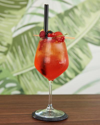 a drink with a straw in a glass on a table at Enny Camere in Alcamo