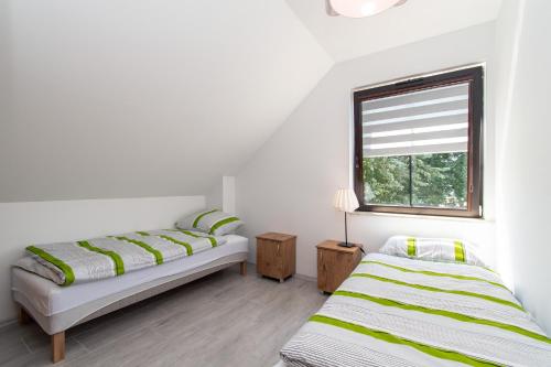 Postel nebo postele na pokoji v ubytování Apartament Perła