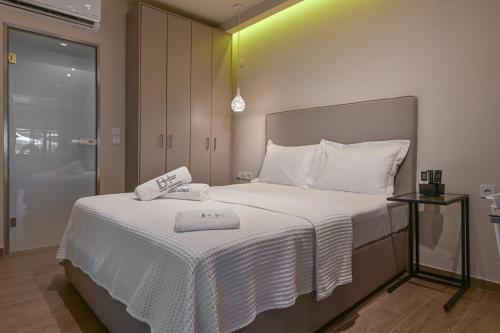 a bedroom with a bed with two towels on it at BLACKHAUS Apartments in Thessaloniki