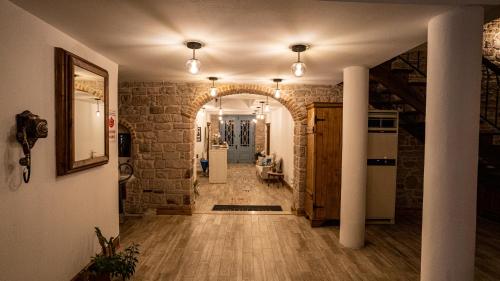 a hallway of a home with a stone wall at Villa Pietra in Ayvalık