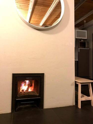 a fireplace in a room with a mirror at Beltes Guest House in Jūrmala