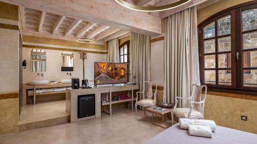 a large room with a bathroom with a bed and a television at 10GR Boutique Hotel & Wine Bar in Rhodes Town