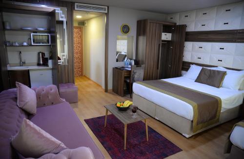 a bedroom with a bed and a living room at Ferman Apart Hotel in Istanbul