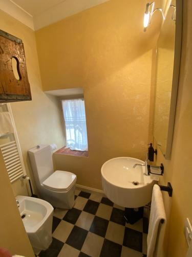 a bathroom with a white toilet and a sink at Appartamento Loreto in Lucca