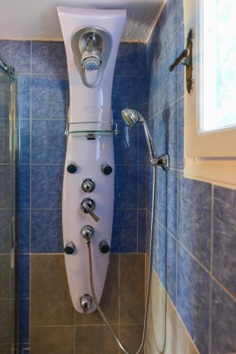 a shower in a bathroom with a shower head at PYTHAGORIO MAGIC VIEw in Pythagoreio